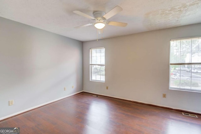 spare room featuring a textured ceiling, dark hardwood / wood-style flooring, and ceiling fan