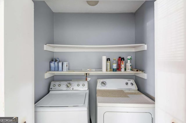 washroom with washing machine and clothes dryer