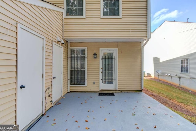 view of exterior entry featuring a patio area