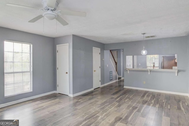 spare room with ceiling fan, wood-type flooring, and a textured ceiling