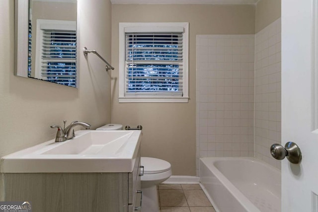 full bathroom featuring toilet, tiled shower / bath combo, vanity, and tile patterned flooring