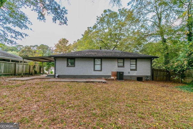 back of property with central AC and a patio area