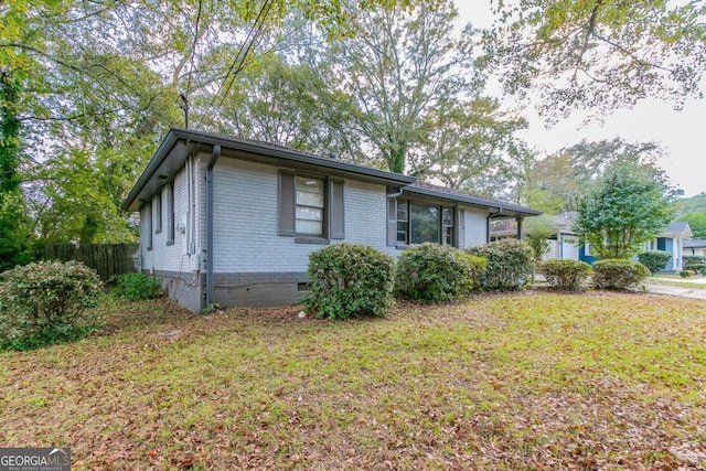 view of side of home featuring a yard