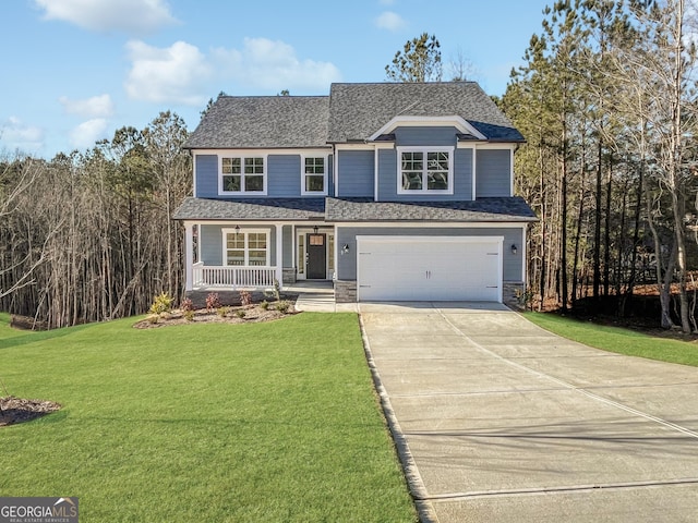 view of front property with covered porch, a front yard, and a garage