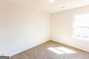 spare room featuring carpet floors