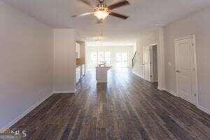 unfurnished room with dark hardwood / wood-style floors and ceiling fan