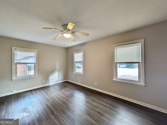 unfurnished room with ceiling fan and dark wood-type flooring