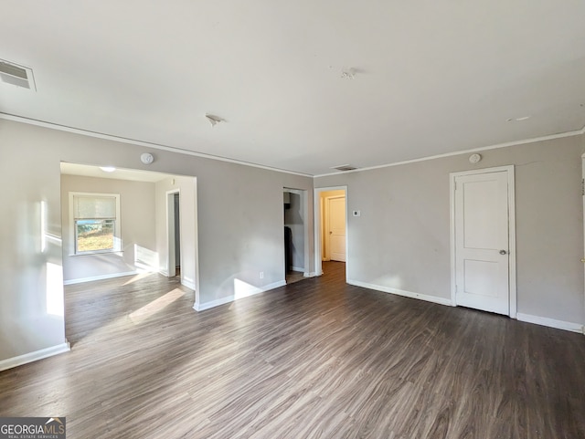 empty room with ornamental molding and hardwood / wood-style flooring