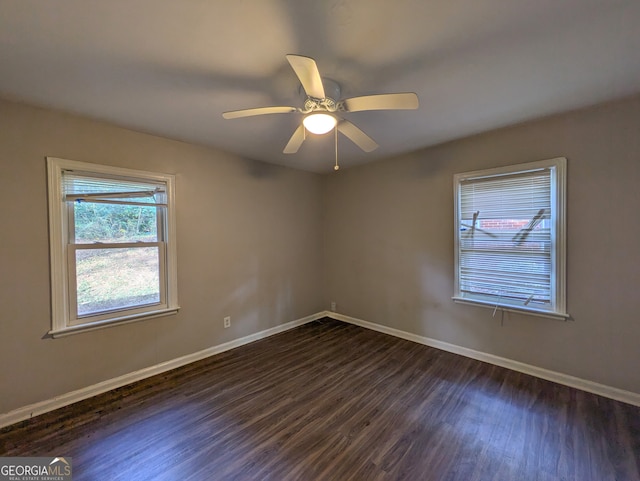 empty room featuring ceiling fan and dark wood-type flooring