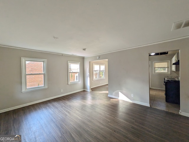 unfurnished room with dark hardwood / wood-style floors and crown molding