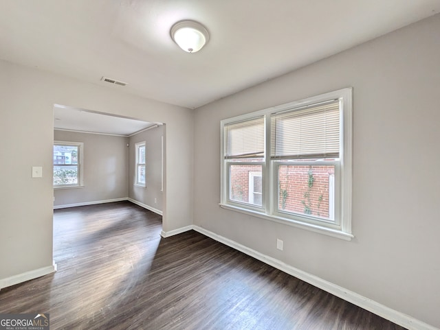 spare room featuring dark wood-type flooring