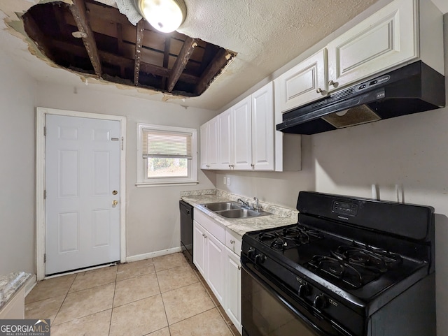 kitchen featuring a textured ceiling, sink, black appliances, light tile patterned floors, and white cabinets