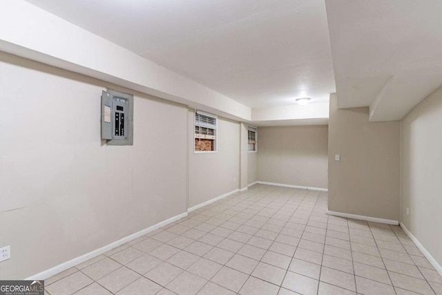 basement featuring electric panel and light tile patterned flooring