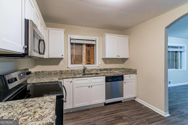 kitchen with white cabinets, stainless steel appliances, sink, and dark hardwood / wood-style flooring