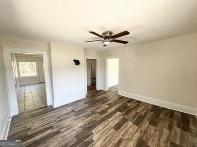 unfurnished room featuring ceiling fan and dark hardwood / wood-style flooring