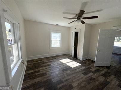 unfurnished bedroom with ceiling fan and dark hardwood / wood-style floors