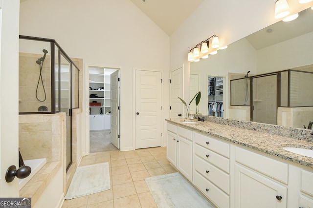 bathroom featuring high vaulted ceiling, shower with separate bathtub, vanity, and tile patterned flooring