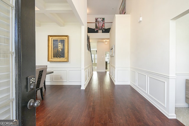 hall with dark hardwood / wood-style flooring, beamed ceiling, and coffered ceiling