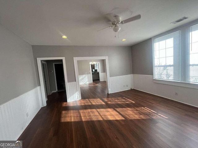 spare room with dark hardwood / wood-style flooring and ceiling fan