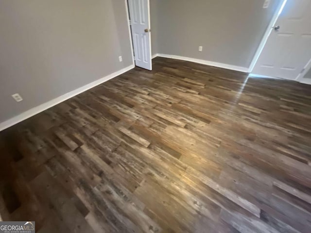 unfurnished bedroom featuring dark wood-type flooring