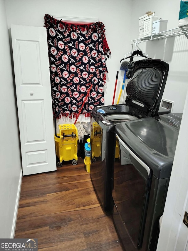 laundry area featuring washer and dryer and dark hardwood / wood-style floors