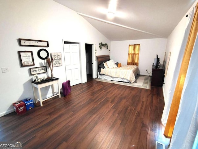 bedroom with lofted ceiling and dark hardwood / wood-style floors