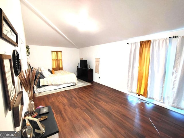 unfurnished bedroom with lofted ceiling and wood-type flooring