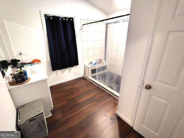 bathroom featuring curtained shower, vanity, and hardwood / wood-style flooring