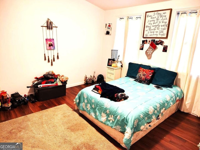 bedroom with dark wood-type flooring