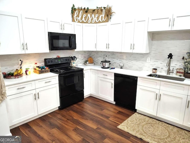 kitchen with dark hardwood / wood-style flooring, black appliances, sink, tasteful backsplash, and white cabinetry