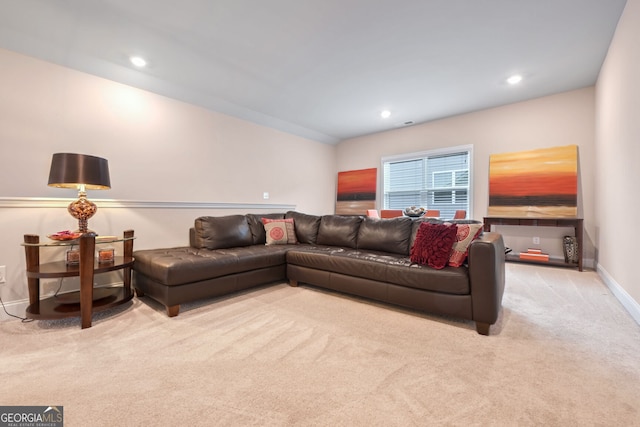 carpeted living area with baseboards and recessed lighting