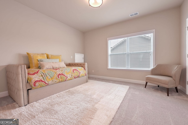 bedroom featuring light colored carpet