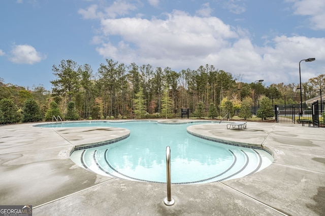 view of swimming pool featuring a patio area