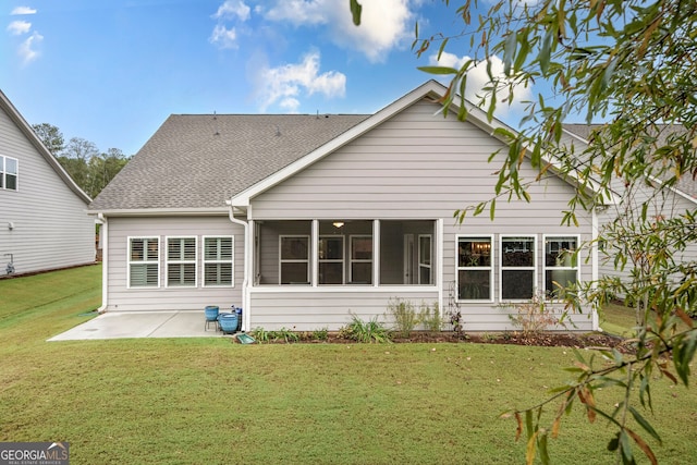 rear view of property featuring a patio, a sunroom, and a yard