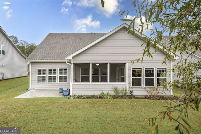 rear view of property featuring a patio, a sunroom, a yard, and roof with shingles
