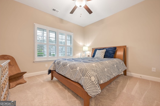 carpeted bedroom with baseboards, visible vents, and ceiling fan