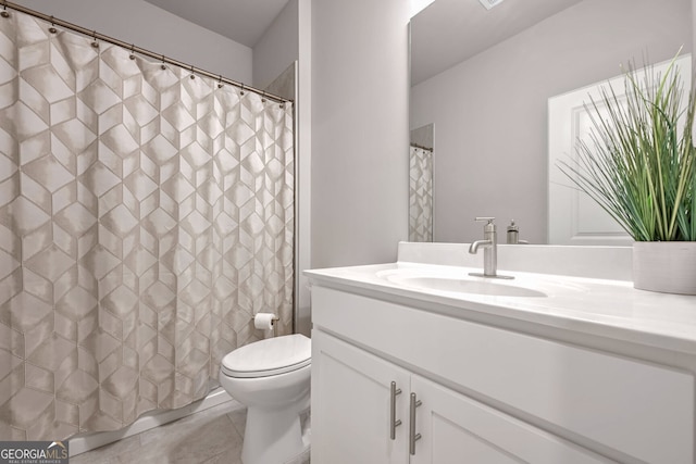 bathroom featuring toilet, vanity, and tile patterned floors