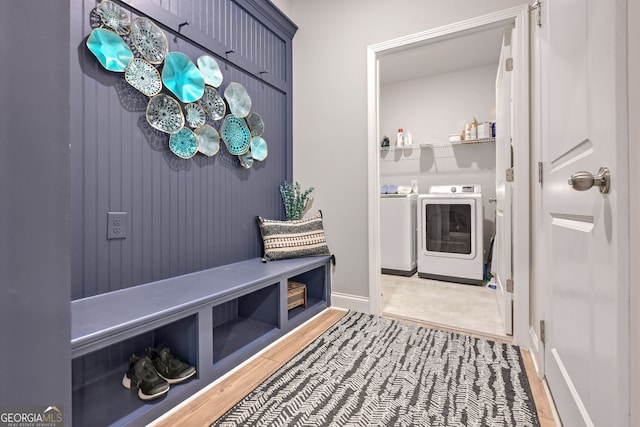 mudroom featuring wood finished floors and independent washer and dryer