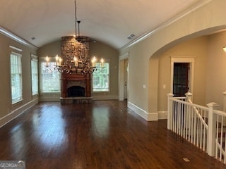 unfurnished living room featuring dark hardwood / wood-style flooring, lofted ceiling, ornamental molding, and an inviting chandelier