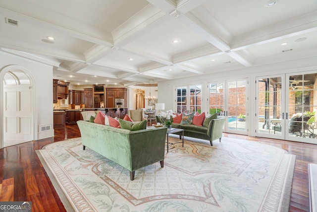 living room featuring french doors, wood-type flooring, an inviting chandelier, coffered ceiling, and beam ceiling