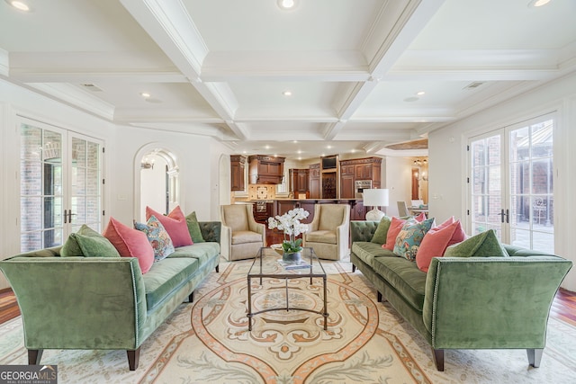 living room featuring coffered ceiling, french doors, ornamental molding, and beam ceiling