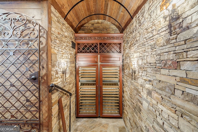 wine room featuring lofted ceiling and wooden ceiling