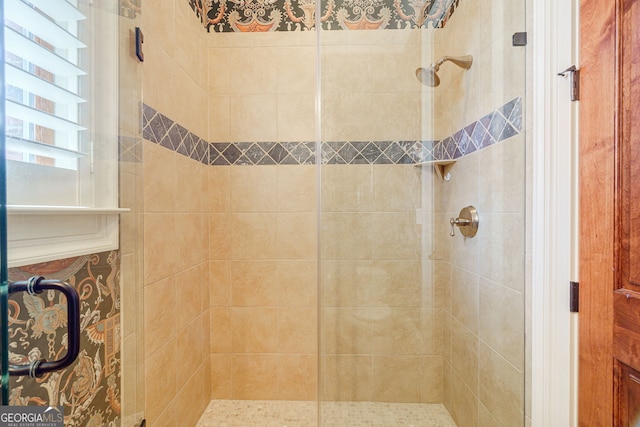 bathroom featuring a shower with door