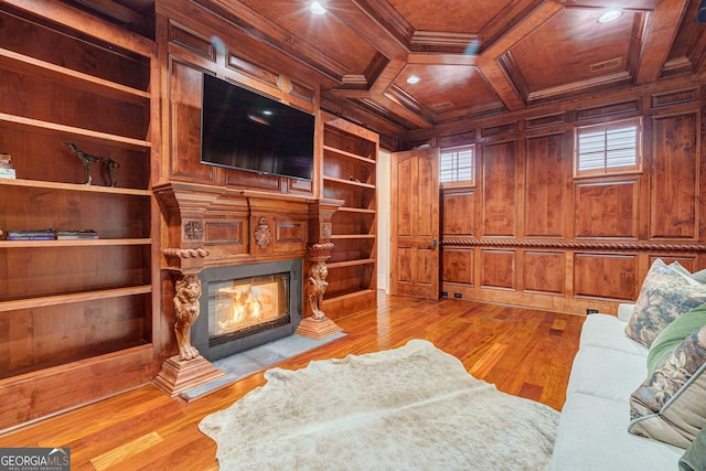 living room featuring built in features, light hardwood / wood-style flooring, wood walls, and wood ceiling