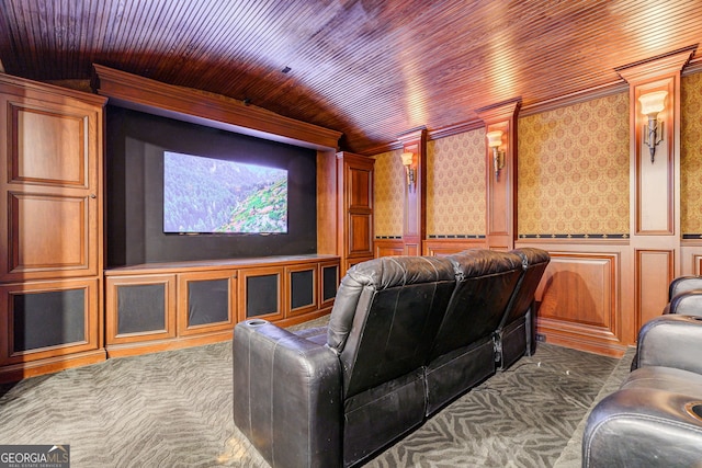 cinema room featuring ornamental molding, dark carpet, vaulted ceiling, decorative columns, and wooden ceiling