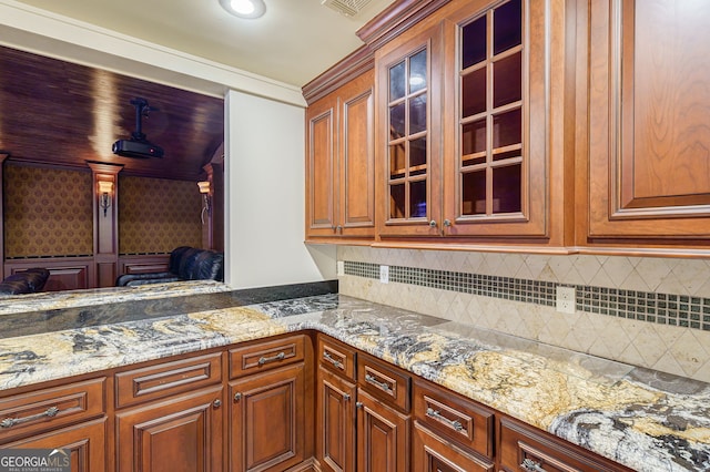 kitchen featuring backsplash and light stone countertops