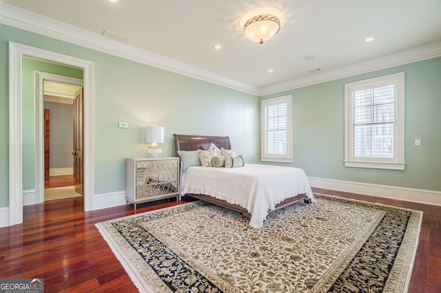 bedroom with ornamental molding and dark hardwood / wood-style floors