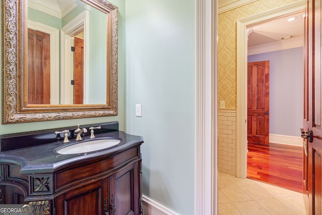 bathroom with vanity, tile patterned flooring, and ornamental molding