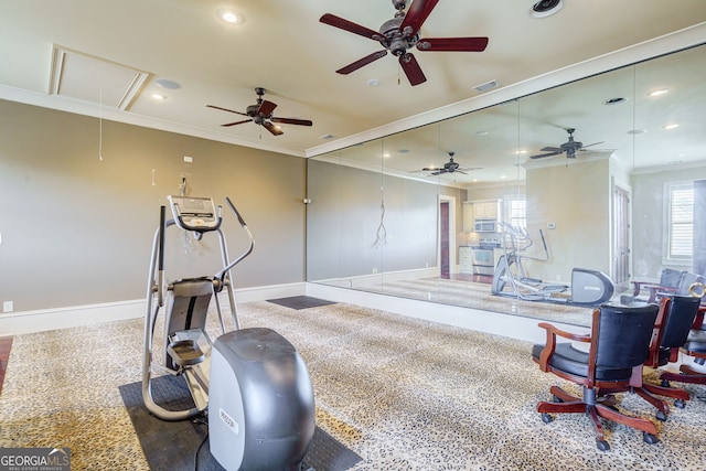 workout room featuring dark colored carpet and crown molding