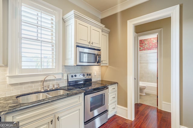 kitchen featuring a wealth of natural light, appliances with stainless steel finishes, sink, and dark hardwood / wood-style floors